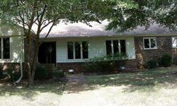 Huge great room and master bedroom with brick accents and fireplace. Both eat-in kitchen and formal dining room. Lots of counter space in kitchen and separate laundry room near a convenient garage-door entry way. Wooded corner lot and private finished