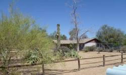 FANTASTIC OPPORTUNITY TO OWN THIS HOME ON 1+ ACRE OF FLAT AND USABLE LAND IN DESERT HILLS. LOCATED RIGHT OFF A PAVED ROAD WITH NORTH/SOUTH EXPOSURE, FENCING AROUND BACKYARD, LUSH VEGETATION AND TREES. PERFECT FOR HORSES OR TOYS. PROPERTY IN NEED OF SOME