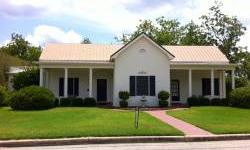 The long, tiled front porch entry with stately columns welcomes you into the home &gives you a dramatic first impression of the formal living room with fireplace ideal for entertaining. An elegant dining room, four spacious bedrooms, three updated baths,
