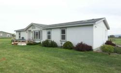 Nicely kept 1855 sq. ft. manufactured home on 3 acres with views all around. There are 4 bedrooms and 2 full baths. Entry is into the Living Room with vaulted ceilings. The Kitchen with island divides the Living room from the Family Room. The split