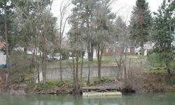 This opportunity doesn't come along every day, 75 ft +/- of primary waterfront in Millwood on the Spokane River, 0.25 acre of land and utilities at the property. This is a highly prized building site for a beautiful custom dream home on the south bank of