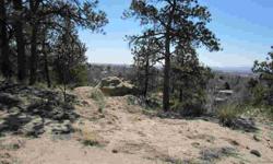 Stunning premium custom view lot in town on a beautiful private bluff. Sweeping city, mountain, & Pikes Peak views. Towering pines, scrub oak, & rock formations. Look down on the world with all the conveniences of being in town, but feeling like you aren
