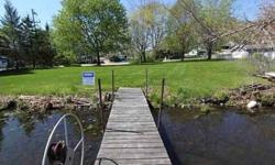Affordable Lauderdale parcel with 75' of water frontage. Large buildable level parcel waiting for your dream home. Mature trees, pier and short walk to Lauderdale Golf Course. Lauderdale is an all sport 834 acres with 16 miles of shoreline. Kettle Moraine