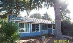 CUTE! CUTE! CUTE! BEACHY Updated 1 level cottage. 2 bd/1bth, 955 sf, detached shop, lot runs street to street. Updates include, custom tile, lighting, new carpet & paint, granite counters, custom window covers. Covered porch goes into wrap around deck.
