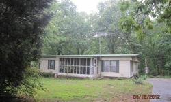 Wonderful Buy!! Nestled on a 1/2 acre level lot this 3 bedroom 2 bath mobile home has wood paneling throughout and stained kitchen cabinets. The living room has a fireplace and there is also a separate den. Enjoy the quite country setting on the screened