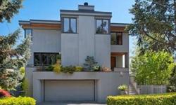 Enjoy this light-filled, custom-designed home with surrounding natural beauty, a uniquely-Seattle setting and peaceful backdrop of Sound, Bay and Canal views. Circular floor plan on the main