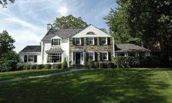 Surrounded by a park-like half-acre of lush green lawns, tall trees and flourishing specimen plantings, this magnificent, 11- room, custom, center hall colonial ? with fully remodeled kitchen, five large bedrooms (including master and au pair suites),