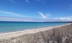 Lake Michigan with 300' of wonderful wide sandy beach front. A mid century Roger Hummel designed beach cottage with views of the Manitous, Fox and sunsets beyond. Cornered glass window walls that have stood the test of time. This is truly an opportunity