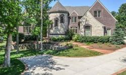 A castle complete w/the turret! Stunning architecture in this elegant all brick home w/curved wrought iron staircase; 15' great room w/wall of windows, gourmet kitchen open to hearth room w/stone fireplace, den has gorgeous woodwork, master bedroom