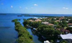 This Longboat Key Club Bayou residence is situated on one of Longboat Key's best waterfront locations. Majestically overlooking Crane's Bayou & Buttonwood Bay with deep sailboat water and room for a 60' +/- yacht, this two story 4 bedroom home, with
