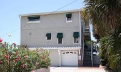Sweeping decks on two floors plus a ground level covered patio offer views of the white sandy beach and the sparkling blue water of the Gulf of Mexico. This north Clearwater Beach home offers an open great room plan with fireplace, two sitting areas with