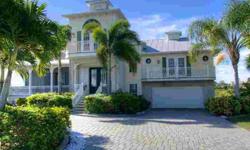 Discover this incredible waterfront home, perfectly poised on the shores of Manasota Key -- a pristine barrier island graced with 11 miles of light sandy beaches. Rich tropical landscaping and an elegant exterior reminiscent of classic Coastal style sets
