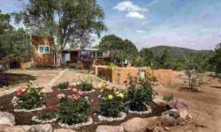 Behind the gates you find one of Santa Fe's original and enchanting family compounds. This authentic and elegant three-level territorial style estate offers views from every window and is surrounded by extravagant gardens with six waterfalls, courtyards,