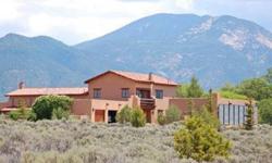 Elegant Taos pueblo style home with high-end amenities and custom detailing. Garden featured in Taos Garden Tour. Built by Ritter in 2003; vaulted soaring wood beam ceilings with 12 foot windows for views of Taos Mtn and Valley. Gourmet kitchen with 6