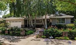 Presenting impressive curb appeal, framed by a canopy of graceful birch trees, this beautifully remodeled home offers traditional style with chic sophistication. Exceptional interior design finishes span throughout with gorgeous hardwood and tiled floors,