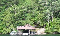 This is the best building lot available on Lake George, immediately north and contiguous to the Lake George Club. 183' of prime waterfront including a large boathouse and docking complex with stone staircase. Spectacular views across the open lake from