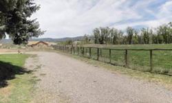 Here's a home in town on .6 acres, outside the city limits, with irrigation water and adjoining a pasture but with no covenants or restrictions! The 2000+ square foot home is all on one level with hardwood floors in the living and dining rooms and two of