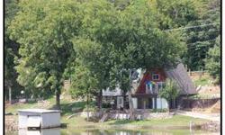 Wow! Deal of 2012! 337' of lake frontage with boathouse & dock. Sherri Vanderkooy has this 4 bedrooms / 1.5 bathroom property available at 296 Disco Loop Rd in Friendsville, TN for $215000.00. Please call (865) 254-9205 to arrange a viewing.Listing