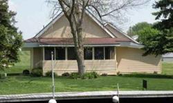 You get 65 feet of Wawasee channel front waters with this absolutely charming home! Three bedrooms one and a half baths, beautiful kitchen open to dining and living areas. Extra room used for office or media or child's play room. Great screened porch