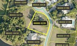 Beautiful lake view lot in Jonathan Harbour - deeded dock will accomadate up to a 36'boat and is just a short boat ride to the Gulf of Mexico - the dock is across the street. This private gated community is just minutes to Sanibel. Seller will finance and