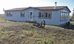 Beautiful home on 26 acres of fenced and crossed fenced property. This 3 bedroom 2 bath house features a free standing wood stove in the living room. The kitchen has a breakfast bar and lots of cabinets and counter space. Bring the sheep, cows and horses
