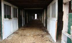 Active horse farm with 7 acre 3 fenced in paddocks, with 16 stall barn and new metal roof, Well and electric on Lot 1 shared with Lot 2. Plus has feed grain system. Surrounded in country setting with mountain views. Property originally engineered for a 4