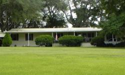 Rolling property w/ oak hammocks and ponds. Once an operating hay farm, now planted in peanuts. Could make great cattle or horse farm or continue leasing it out for crops. Home is custom designed and features spacious kitchen w/ island work center, huge