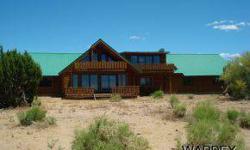 This is a completely cutom log home. This home is not complete and will need to be finished but is located in a great area along the base of the mountains with extremely unique views and vegetation, approx 3600' elevation and aonly 45 minutes from kingman