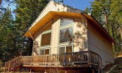 Newer cabin on half acre lot backing to community green belt. Large cathedral windows let in lots of natural light. Tongue and groove wood paneling throughout give the home a warm and cheerful feel. Short walk to community pool or the Wenatchee River -