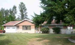 Solid 60's built rambler with 3 bedrooms on over half an acre in Enumclaw. Large living room with fireplace and separate dining room. (Hardwoods under carpet.) Extra finished room with many possibilities. Outside, home has cedar siding and soffits. HUGE