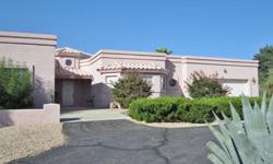 This Custom 3 bedroom, 2 bath has 2,387 SF and sit?s on an acre in gorgeous Hualapai Foothills. Spacious tile entry with ornate pillars opens to the living room with large bay window and gas fireplace. Dining area is open to both the living room and