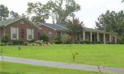 Large brick home in good area on over 8 acres. Enter into entry area with wood floors in living, dining, den. Fireplace in den. 3 large bedrooms, 3 baths, sunroom. Enjoy morning coffee on patio or gazebo surrounded by flowers & trees. Workshop &