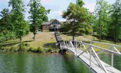 LEWIS SMITH LAKE - The perfect weekend retreat on 3 acres of land and over 500 feet of water frontage. This doll house has 3 bedrooms and 2 baths. The open great room, dining room and kitchen has a vaulted ceiling and tile floors. There are french doors