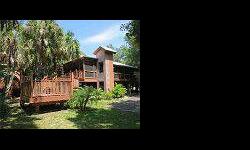 Are you tired of cookie cutter homes on postage stamp sized lots? If so you will love the uniqueness of 1704 Spoonbill. This wonderful stilt home is situated on Â½ acre of heavily wooded tropical forest. Live Oak, bamboo, palm trees and multitudes of