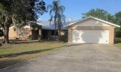 Florida Ranchette with 4 bedrooms and 3 full baths. Entering this home you will find a very larger living room with a fireplace setting in the middle of the room, with openings on both sides. Home also features a separate dining room and 2 car garage. One