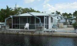 Terrific property for summer fun. Spacious double wide with 2 bedroom 3 bath plus a den. Screen in porch. 45 ft concrete dock with davits. Carport plus plenty of parking Quick access to Tarpon Basin. Great neighborhood with 2 boat ramps and walking