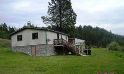 Want acreage on the Pend Oreille river? Look no more! 6.2 acres with 700(mol)feet of grassy frontage. Enjoy the lazy river flowing by and the beautiful panoramic mountain views from the deck of this comfortable home. This cozy 2Bd, 1Ba home sits on an