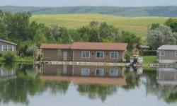 Lake Home for sale at Brush Lake, 3 miles North of Mercer, North Dakota. All furniture, beds, cooking utensils, and appliances included. Lot size is 31000 sq.ft. 2 garages and a storage shed 2 docks a pontoon, trailer, and pontoon lift. Troy built 16 hp