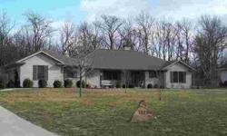 LOCATED BETWEEN CHARLESTON AND MATTOON. Beautiful custom built ranch style home on wooded lot. You'll love the hickory cabinets, hardwood floors, pantry and double ovens that you will find in the kitchen. Entertaining will be made easy with the breakfast