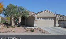 Beautiful home (Aurora model) backing to green golf course and Catalina Mountains, also pretty city lights at night. Gourmet kitchen with flat surface range, 48 inch custom cabinets and granite counter-tops. Family room has a warm cozy fireplace. Seller