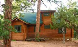 Three very private acres of tall Ponderosa pines frame this 3BR/2BA full log cabin. Cathedral ceiling w/open wood beams, log rail accents, corner propane FP, open kitchen w/island, sunny dining area & huge loft w/full bath. Metal roof, stone faced
