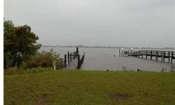 The value is in the land! This parcel is direct bayfront on Lemon Bay with full bay views. Property has boat dock with easy access to the IntraCoastal Waterway. The house features 4 bedrooms, 2 and a half baths, granite countertops in kitchen with wood