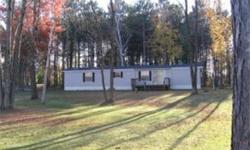 BEAUTIFUL FLAT LOT WITH ALMOST 200 FEET OF RIPRAPPED WATER FRONTAGE NEAR BIG WATER OF LAKE HOLCOMBE. PRICE INCLUDES 2 BEDROOM, 2 BATH REDMAN RIDGEDALE MANUFACTURED HOME, PRIVATE WELL, CONVENTIONAL SEPTIC, 2 STORAGE SHEDS. EXCELLENT LOCATION YET QUIET AND