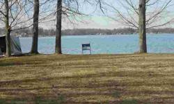 Lovely level lakefront lot with sandy beach and breathtaking view! Newer seawall. Dock and storage shed included. Back lot across the paved drive included. Sewer stub on lakefront lot, sewer assessment paid. ONE OF A KIND! With Gun Lake private