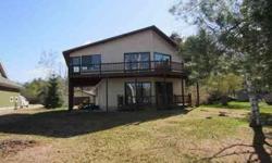 Great opportunity to be on Torch River Bayou just minutes to Torch Lake by boat or walking! Beautiful lot with chalet, garage, with worksop, and extra outbuilding. Very charming home with great views and waterfront out your front door! Fireplace, 3