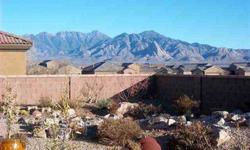 Large 55x10 ft. patio with large rock waterfall, and mountain views. Beautiful interior colors. All tile floors except bedrooms. Granite kitchen counters and bar, gas cooktop, wall oven, opens to living room, eat in kitchen as well as large dining area.