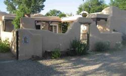 This truly authentic traditional family compound in Santa Cruz near Espanola contains a main house with studio apartment and an additional two room remodeled outbuilding. This fully walled and fenced compound on almost a half of an acre offers a peaceful