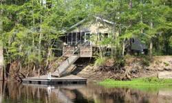 Imagine coming home from a great day on the boat, pulling up to your own dock and relaxing with the sound of water from an artesian spring falling in the background... This amazing property is perfect for a vacation getaway spot or a permanent vacation