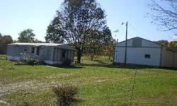 1990 Two bedroom mobile home, on Just over one acre, partially fenced. 30 by 40 pole barn garage, Large deck on back, small Porch on front. Kitchen, bath and laundry area have new solid plywood floors, Living room has new carpet and paint, kids room has