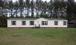 Enjoy this lovely Shult manufactured 32'x64' doublewide located on a large 1.41 acre lot in Azalea Point that backs to a wooded area and is just a short drive away from downtown Guyton. This home features a spacious open floor plan, living room, dining